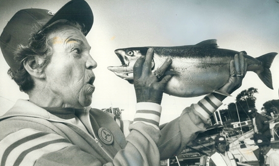 Hazel McCallion with fish, 1980 Great Salmon Hunt at Port Credit Marina. The 7 lb Coho was caught by 12-year-old Kevin Annis. Google image from https://www.toronto.com/news-story/10324692-timeline-key-moments-in-the-life-of-mississauga-s-longest-serving-mayor-hazel-mccallion-as-she-turns-100/
